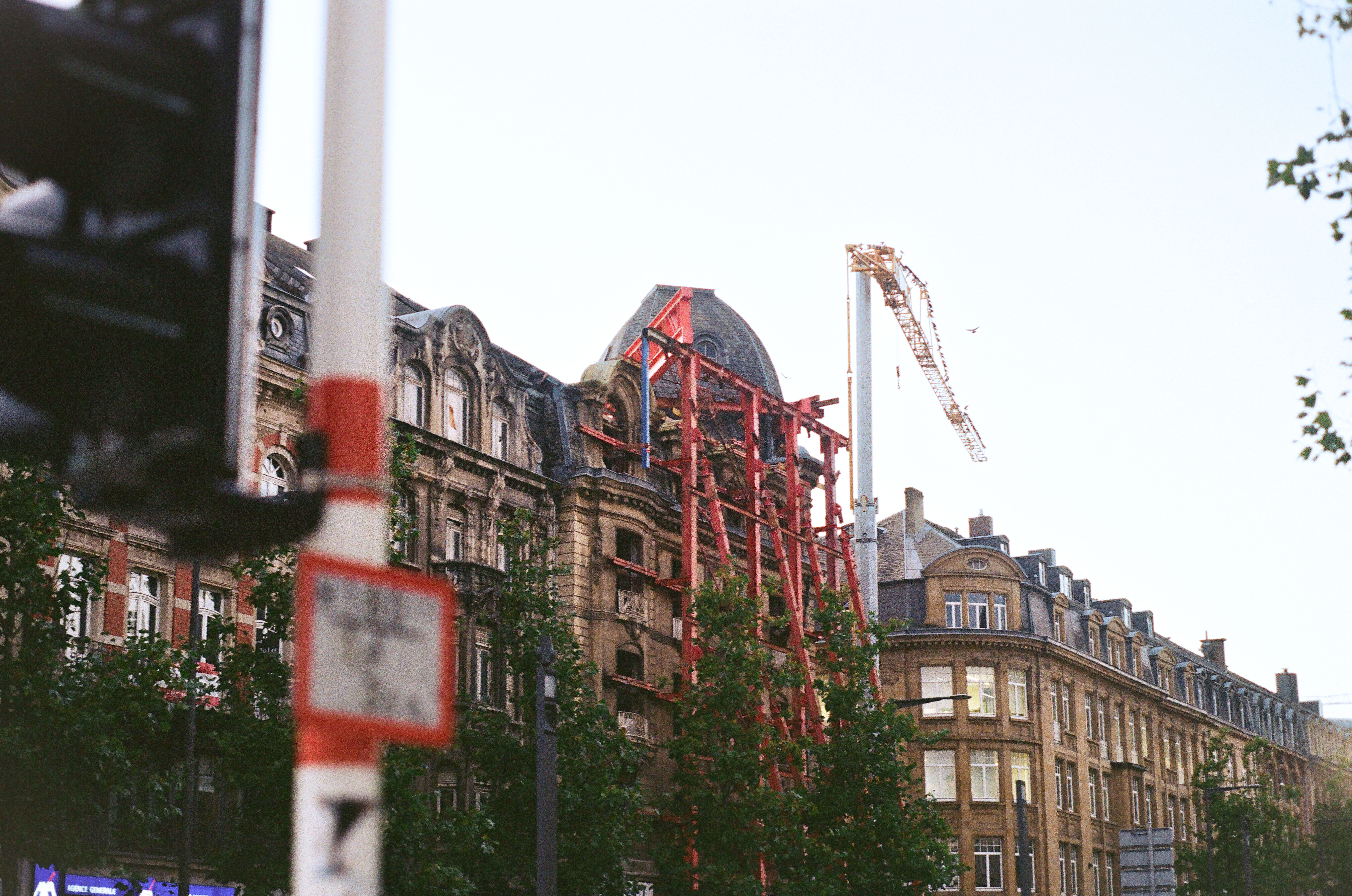 Building under construction with red steel supports
